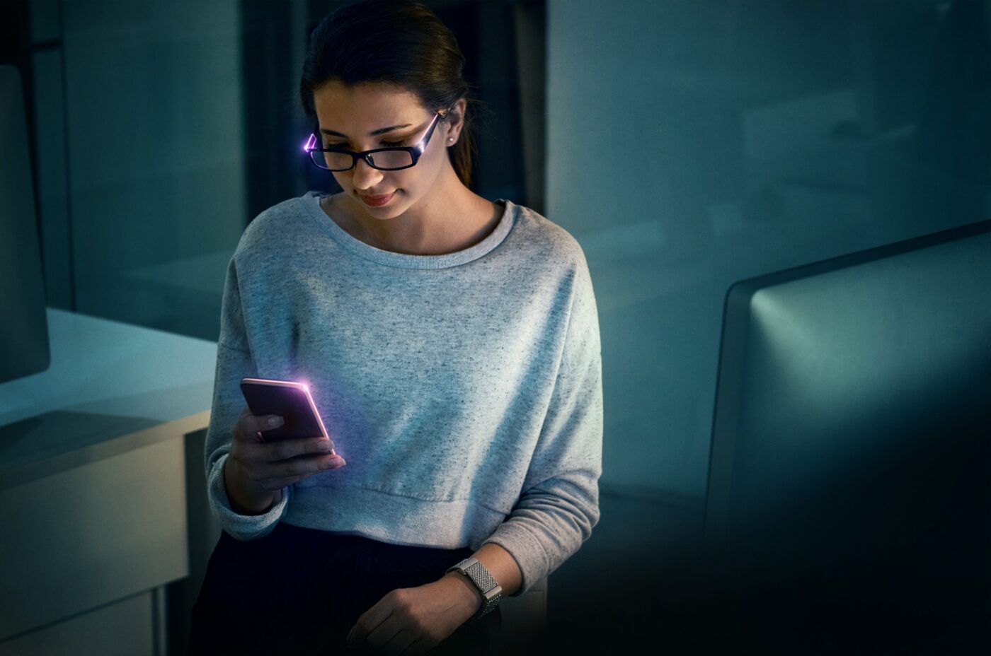 Arm’s illustrative artwork of a woman wearing smart glasses and a watch while looking at a smartphone.